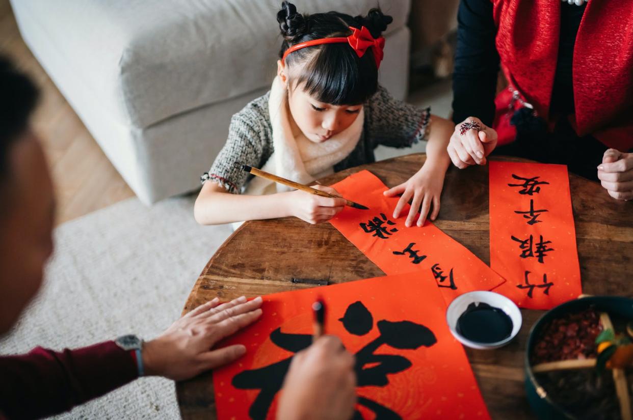 <span class="caption">Grandparents are teaching Chinese calligraphy to their granddaughter and how to write Chinese New Year auspicious messages.</span> <span class="attribution"><a class="link " href="https://www.gettyimages.com/detail/photo/grandparents-practising-chinese-calligraphy-for-royalty-free-image/1267808033?adppopup=true" rel="nofollow noopener" target="_blank" data-ylk="slk:AsiaVision/E+ via Getty Images;elm:context_link;itc:0;sec:content-canvas"> AsiaVision/E+ via Getty Images</a></span>