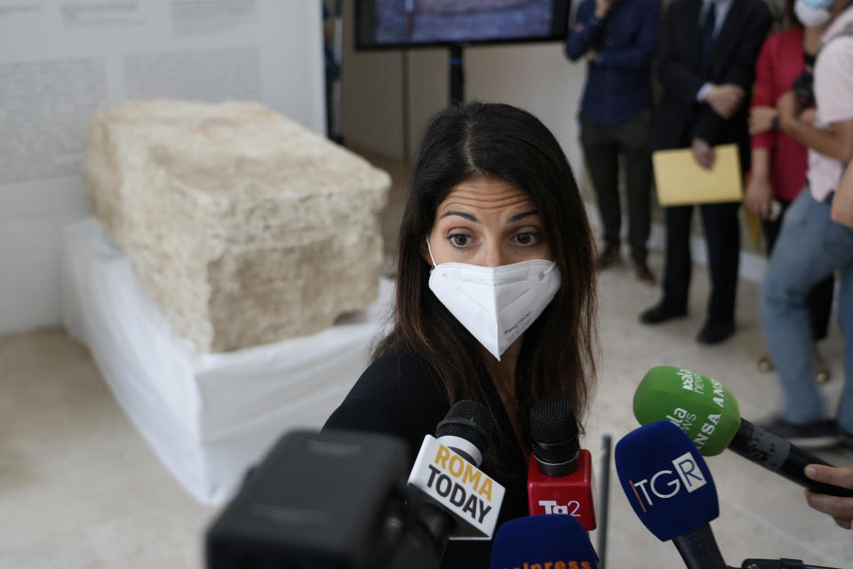 Rome's Mayor Virginia Raggi, answers to journalists' questions, during the presentation to the press of an archeological finding emerged during the excavations at a Mausoleum in Rome, Friday, July 16, 2021. The monumental pomerial stone is dating back to Roman Emperor Claudio and was used to mark the ‘pomerium’ the sacred boundaries of the ‘Urbe’, the city of Rome, during the Roman empire. (AP Photo/Domenico Stinellis)