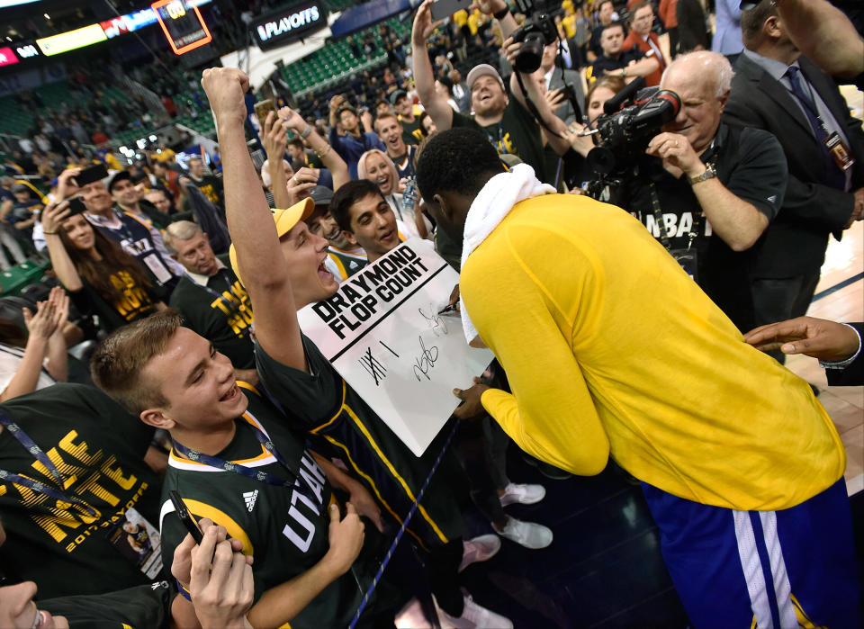 Draymond Green reviews, signs and initials a Jazz fan's very specific stat sheet. (Getty Images)