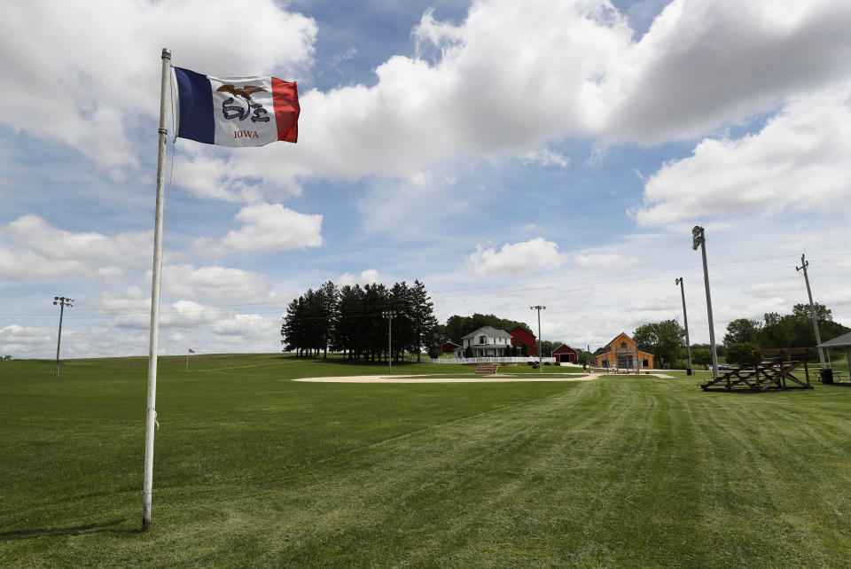 FILE - In this June 5, 2020, file photo, an Iowa flag waves in the wind over the field at the Field of Dreams movie site in Dyersville, Iowa. The St. Louis Cardinals have replaced the New York Yankees as the opponent for the Chicago White Sox in the Field of Dreams game on Aug. 13 at Dyersville. A temporary 8,000-seat stadium is nearing completion at the site, about 200 miles west of Chicago, adjacent to where the movie was filmed on a diamond in a cornfield. This would be the major league game played in Iowa. (AP Photo/Charlie Neibergall, File)