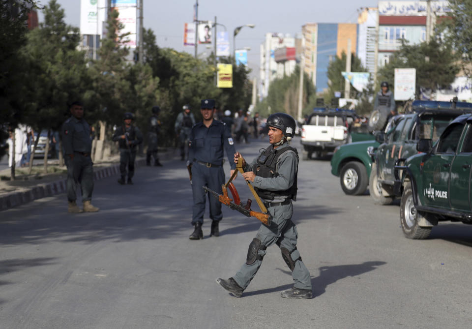 Security personnel arrive at the site of a deadly suicide bombing that targeted a training class in a private building in the Shiite neighborhood of Dasht-i Barcha, in western Kabul, Afghanistan, Wednesday, Aug. 15, 2018. Both the resurgent Taliban and an Islamic State affiliate in Afghanistan have targeted Shiites in the past, considering them to be heretics. (AP Photo/Rahmat Gul)