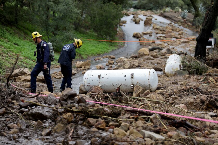 SUMMERLAND, CA - JANUARY 10: Montecito Summerland Fire Protection District responds to a rockslide where two 500-gallon propane tanks were washed up along the 800 block of Toro Canyon Road, Toro Canyon, Tuesday, Jan. 10, 2023 in Summerland, CA. A spokesperson with the fire district said the tanks were found in the early afternoon yesterday. One of the tanks is empty and the other is a one third full and were from a home. They were continuing to monitor the air from a leak coming from one of the tanks. (Gary Coronado / Los Angeles Times)