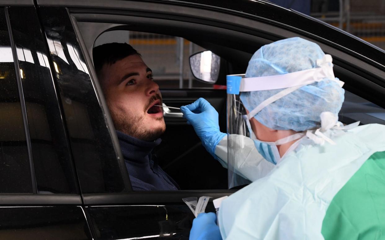 Man getting a Covid test  - Justin Kernoghan