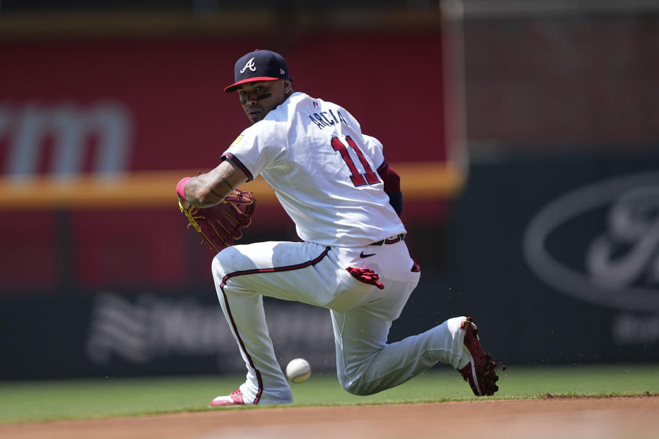 Atlanta Braves' Orlando Arcia (11) misses a ball hit by Pittsburgh Pirates' Rowdy Tellez (44) in the first inning of a baseball game, Sunday, June 30, 2024, in Atlanta. (AP Photo/Brynn Anderson)