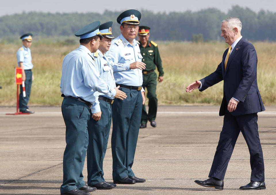 U.S. Secretary of Defense Jim Mattis, right, is greeted by Vietnam's Air Force Deputy Commander Gen. Bui Anh Chung, second from right, as he visits Bien Hoa airbase, where the U.S. army stored the defoliant Agent Orange during the Vietnam War, in Bien Hoa city, outside Ho Chi Minh city, Vietnam, Wednesday, Oct. 17, 2018. (Kham/Pool Photo via AP)