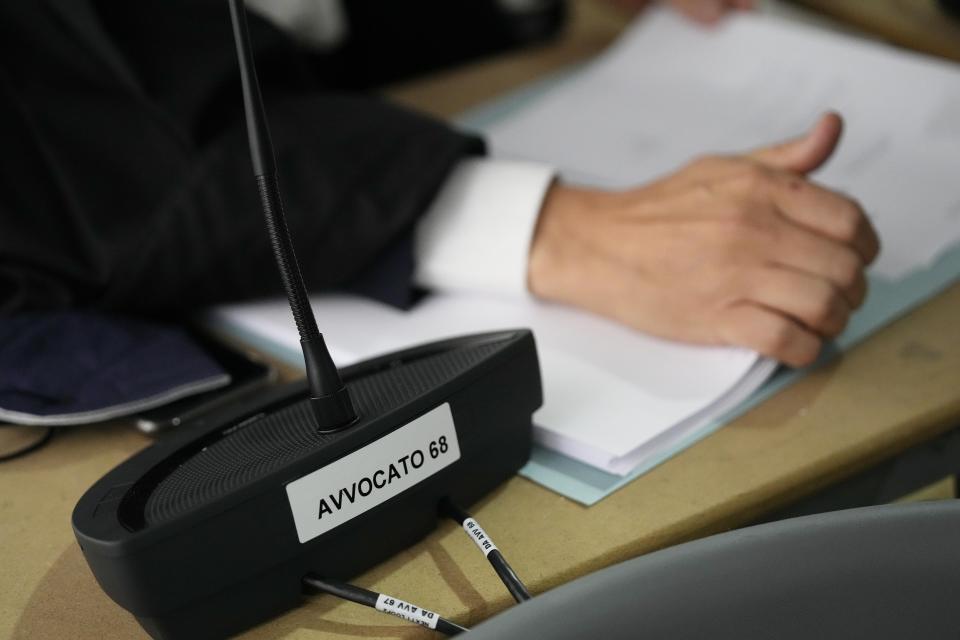 A Lawyer attends the opening of the first hearing of the trial for the Morandi bridge collapse at the Genoa's Palace of Justice Thursday, July 7, 2022. Forty-three people were killed when a large stretch of the Morandi Bridge broke off, August 14, 2018, on the eve of one of Italy's biggest vacation holidays. (AP Photo/Antonio Calanni)