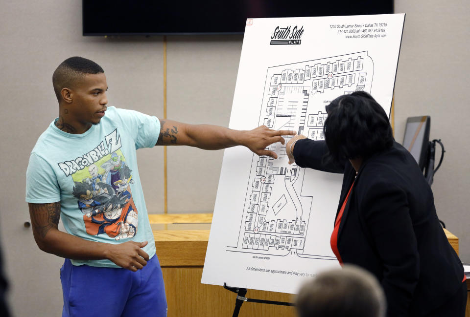 In this Tuesday, Sept. 24, 2019, photo, victim Botham Jean's neighbor Joshua Brown, left, answers questions from Assistant District Attorney LaQuita Long, right, while pointing to a map of the South Side Flats where he lives, while testifying during the murder trial of former Dallas Police Officer Amber Guyger, in Dallas. Authorities say that Brown was killed in a shooting Friday, Oct. 4. (Tom Fox/The Dallas Morning News via AP, Pool)