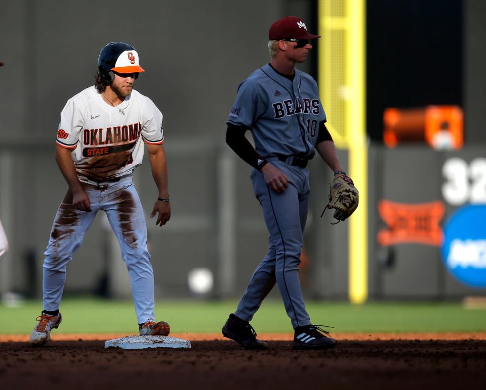Oklahoma State's Caeden Trenkle (28) reacts after stealing a base next to Missouri State's Walker Jenkins (10) in the fourth inning during the NCAA Stillwater Regional baseball game between Oklahoma State Cowboys and Missouri State Bears at the O'Brate Stadium in Stillwater, Okla., Friday, June, 3, 2022. 