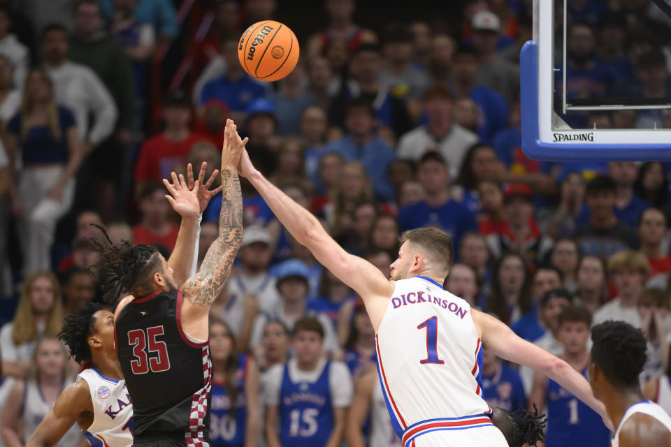 Kansas center Hunter Dickinson (1) tries to block a shot by North Carolina Central guard Po'Boigh King (35) during the first half of an NCAA college basketball game in Lawrence, Kan., Monday, Nov. 6, 2023. (AP Photo/Reed Hoffmann)