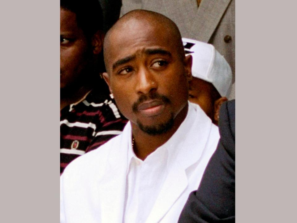 FILE - In this Aug. 15, 1996, file photo, rapper Tupac Shakur attends a voter registration event in South Central Los Angeles. It was an odd couple:  Records show that Iowa Department of Human Services Director Jerry Foxhoven had an unusually strong interest in the late Tupac Shakur during his two-year tenure, which abruptly ended last June 2019.  He had weekly “Tupac Fridays” to play his music in the office, he traded Tupac lyrics with employees and he marked his own 65th birthday with Tupac-themed cookies, including ones decorated with the words “Thug life.” (AP Photo/Frank Wiese, File)