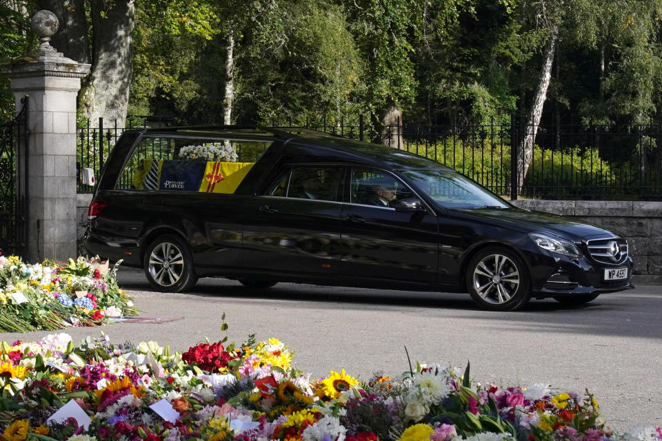 The hearse carrying the coffin of Queen Elizabeth II, draped with the Royal Standard of Scotland, leaving Balmoral as it begins its journey to Edinburgh. Picture date: Sunday September 11, 2022.