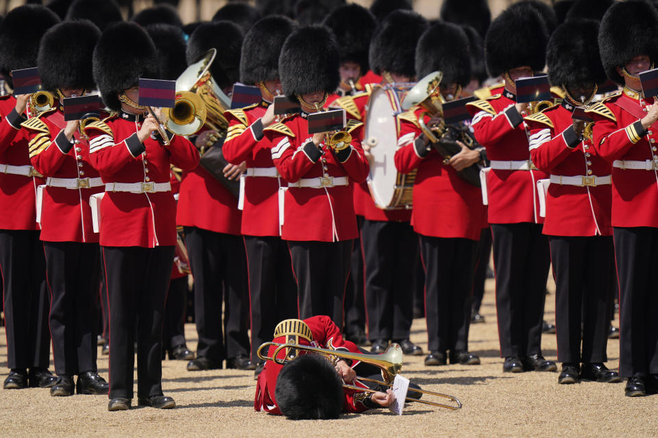 A trombone player of the military band faints during the Colonel's Review, the final rehearsal of the Trooping the Colour, the King's annual birthday parade, at Horse Guards Parade in London, Saturday, June 10, 2023. (AP Photo/Alberto Pezzali)