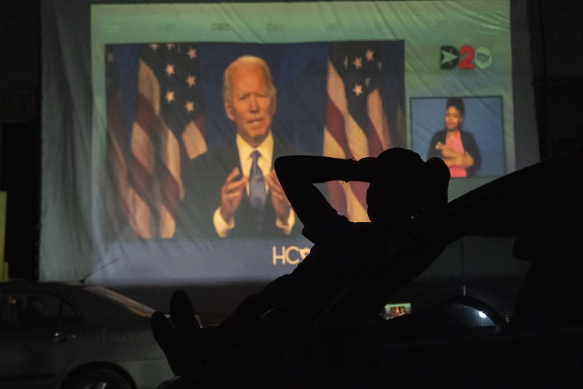 HOUSTON, TX - AUGUST 20: A Joe Biden supporter watch DNC as Joe Biden appears on a large screen during a drive-in DNC watch event on August 20, 2020 in Houston, Texas. The convention, which was once expected to draw 50,000 people to Milwaukee, Wisconsin, is now taking place virtually due to the coronavirus pandemic. (Photo by Go Nakamura/Getty Images)