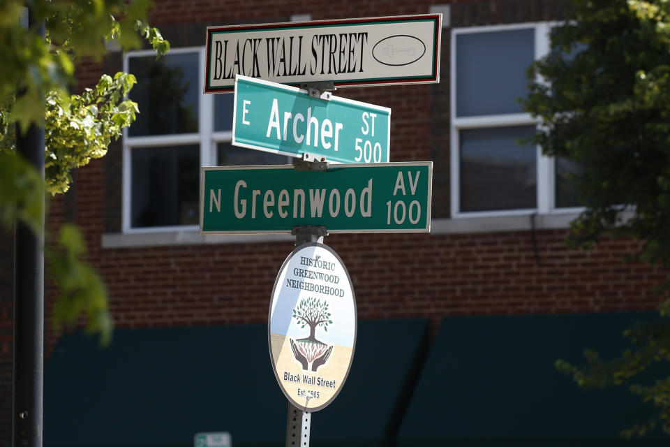 A sign marks the intersection of Green and Archer, the former home of Black Wall Street, in Tulsa, Okla., Monday, June 15, 2020, on the other side of what's historically the city's white-black dividing line from where President Donald Trump will rally Saturday. (AP Photo/Sue Ogrocki)