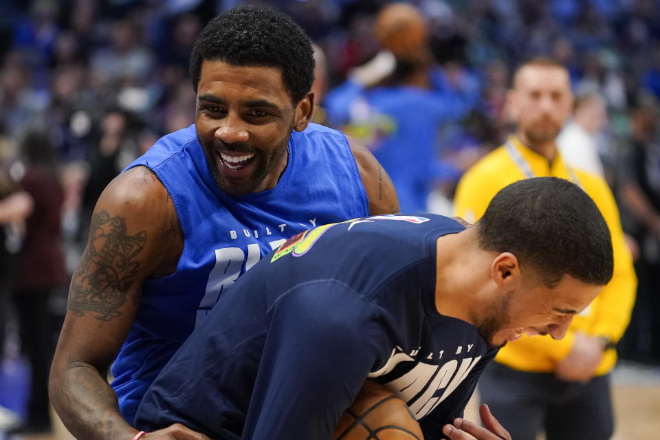 Dallas Mavericks guard Kyrie Irving embraces Indiana Pacers guard Tyrese Haliburton before an NBA basketball game in Dallas, Tuesday, Feb. 28, 2023. (AP Photo/Sam Hodde)