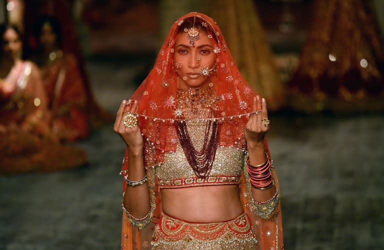 <p>A model presents a creation by Indian fashion designer Tarun Tahiliani during the FDCI India Couture week 2016 in New Delhi on July 21, 2016. </p>