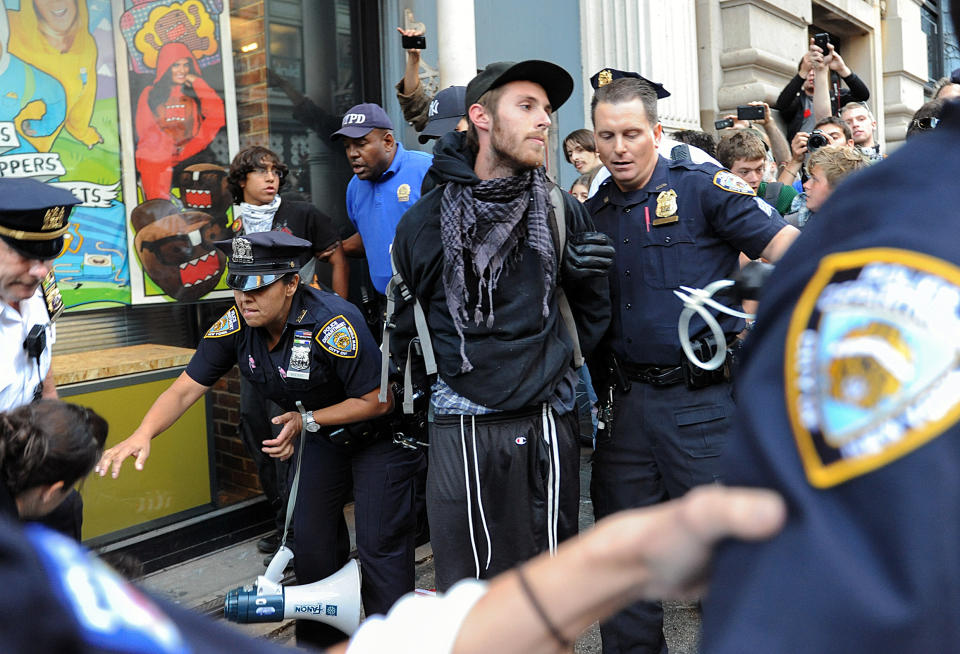 A person associated with the Occupy movement is arrested on a march down Broadway Street in New York enroute to Zuccotti Park, Saturday, Sept. 15, 2012. Monday marks the one year anniversary of the Occupy movement. (AP Photo/Stephanie Keith)