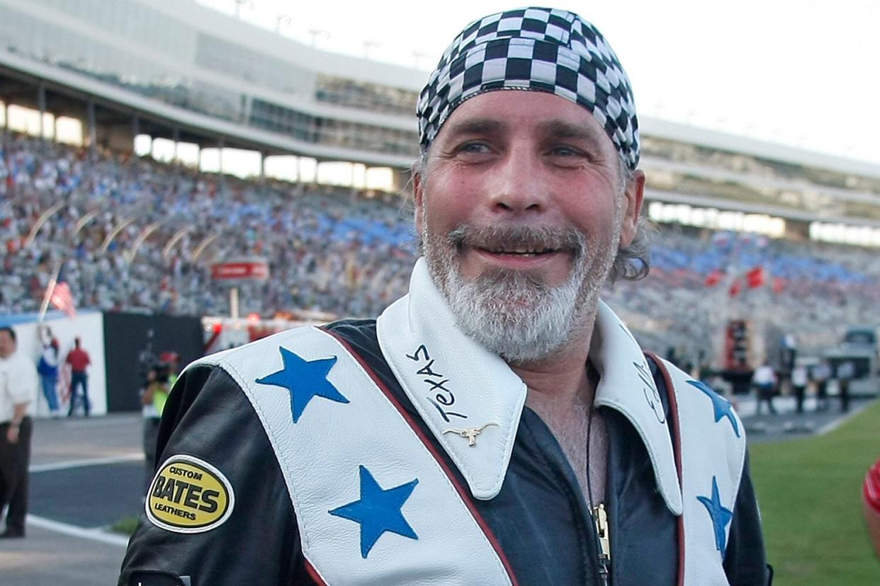 Robbie Knievel smiles moments after he successfully jumped more than 200 feet over service vehicles before the start of the IZOD IndyCar Series Firestone 550 at Texas Motor Speedway in Fort Worth, Texas, Saturday, June 5, 2010.