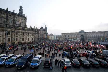 People gather for an anti-immigration demonstration organised by rightwing movement Patriotic Europeans Against the Islamisation of the West (PEGIDA)at theaterpkatz in Dresden, Germany October 19, 2015. REUTERS/Fabrizio Bensch