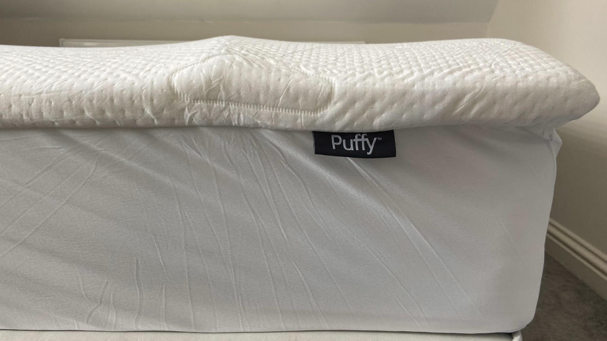  Side view of the Puffy Deluxe Mattress Topper on a bed 