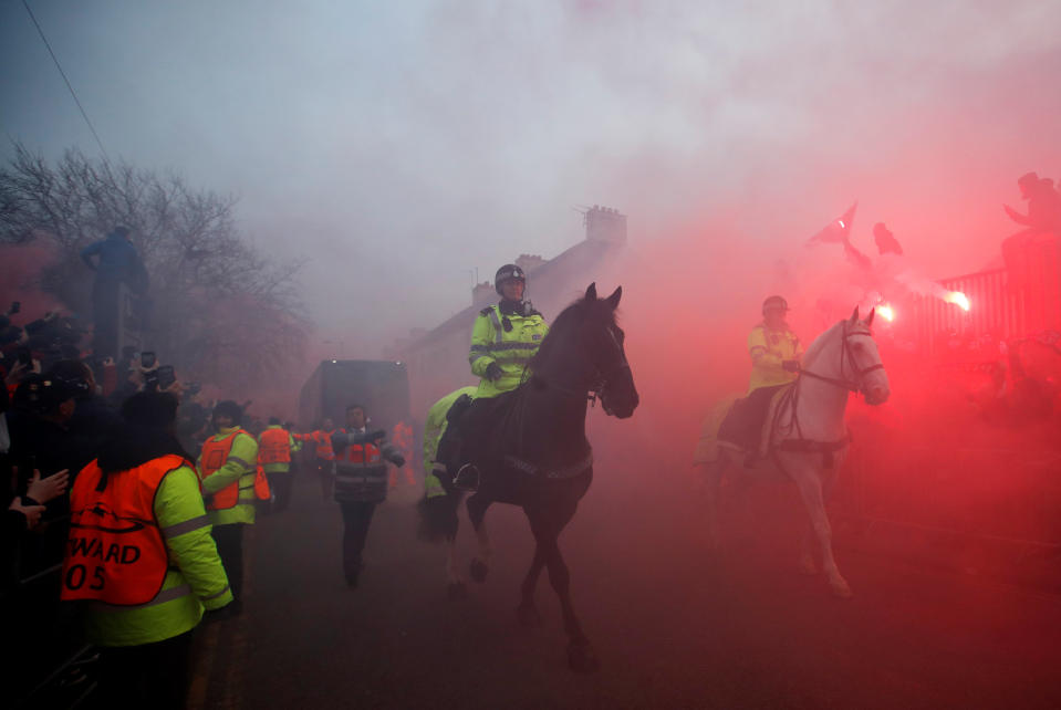 <p>Soccer Football – Champions League Quarter Final First Leg – Liverpool vs Manchester City – Anfield, Liverpool, Britain – April 4, 2018 Police officers clear the road as Liverpool fans set off flares as the Manchester City team bus approaches the stadium before the match Action Images via Reuters/Carl Recine </p>