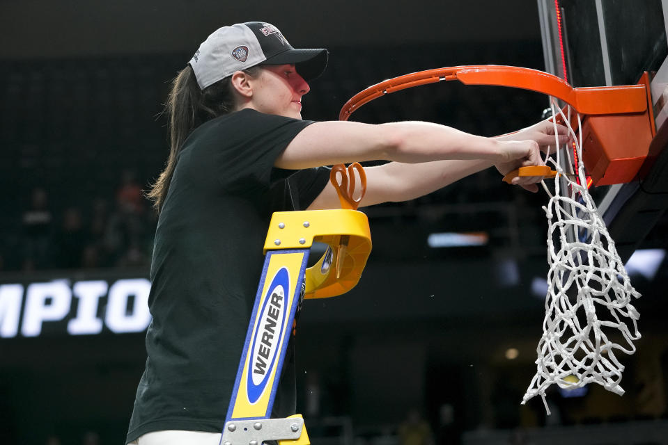 Iowa guard Caitlin Clark cuts a piece of the net after Iowa defeated LSU in an Elite Eight round college basketball game during the NCAA Tournament, Monday, April 1, 2024, in Albany, N.Y. (AP Photo/Mary Altaffer)