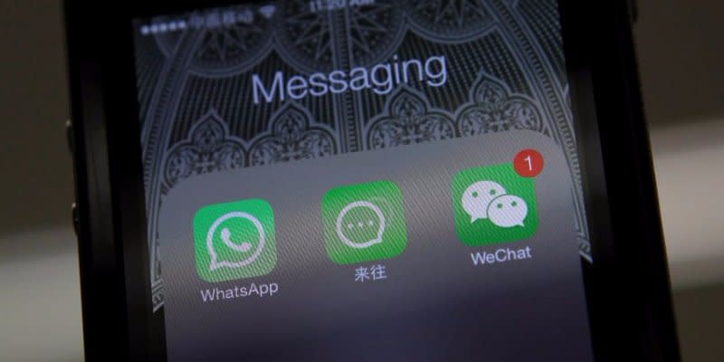 FILE PHOTO: Icons of messaging applications WhatsApp of Facebook (L), Laiwang of Alibaba Group (C) and WeChat, or Weixin, of Tencent Group, are seen on the screen of a smart phone on this photo illustration taken in Beijing February 24, 2014.  REUTERS/Barry Huang/File Photo