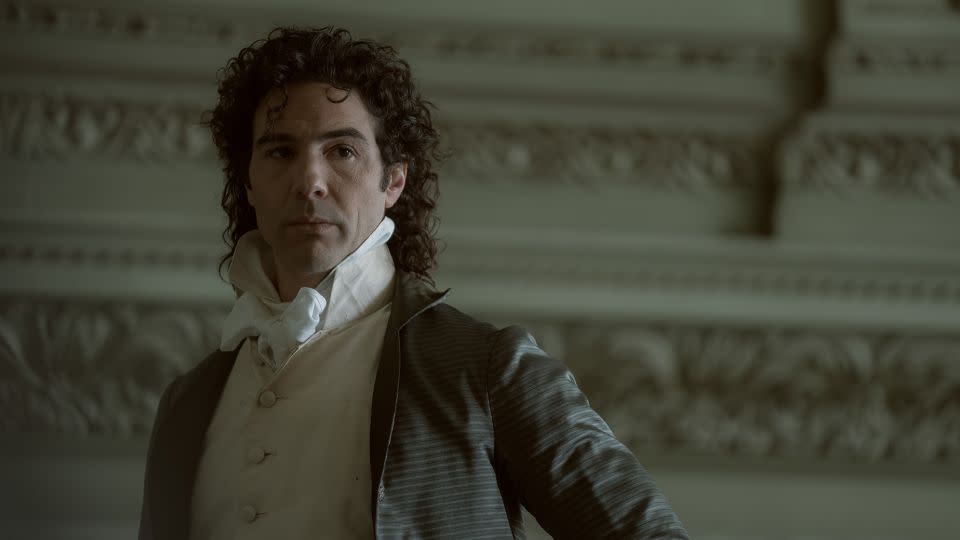 Paul Barras (played by Tahar Rahim) shows off a sumptuous curly mullet in "Napoleon." - Aidan Monaghan/Courtesy Apple