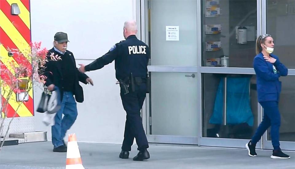 Former Pierce County Sheriff Paul Pastor (left) is welcomed outside the emergency entrance to Saint Joseph Medical Center in Tacoma, Washington, after two Pierce County Sheriff’s deputies were shot during a SWAT arrest on Tuesday, March 15, 2022.