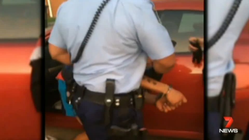 Police handcuff the man and take him to the station, later charging him with multiple offences. Photo: Supplied