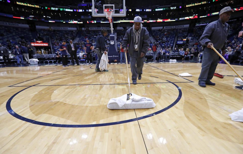 Workers mop the court during a delay for the start of an NBA basketball game against the Indiana Pacers in New Orleans, Wednesday, Feb. 7, 2018. (AP)