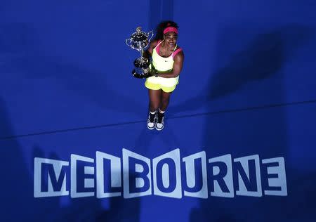 Serena Williams poses with her trophy after defeating Maria Sharapova of Russia in their women's singles final match at the Australian Open 2015 tennis tournament in Melbourne January 31, 2015. REUTERS/Carlos Barria