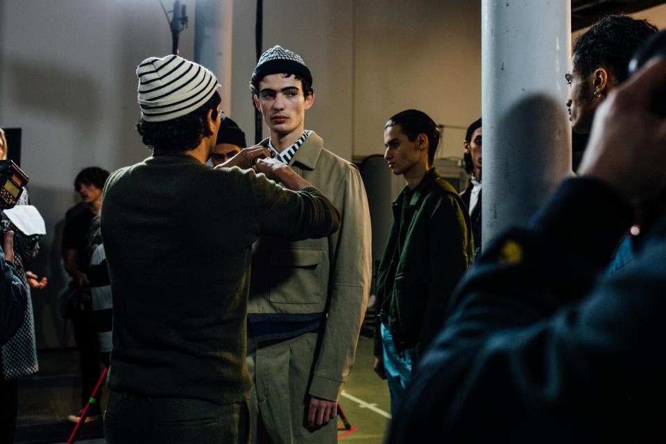 Haider Ackermann fixes a model’s collar