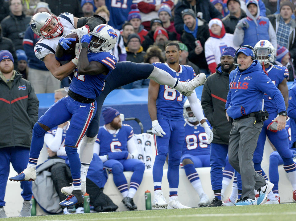 <p>New England Patriots tight end Rob Gronkowski, left, makes a catch as Buffalo Bills cornerback Tre’Davious White (27) defends during the second half of an NFL football game, Sunday, Dec. 3, 2017, in Orchard Park, N.Y. Bills head coach Sean McDermott, right, looks on during the play. (AP Photo/Adrian Kraus) </p>