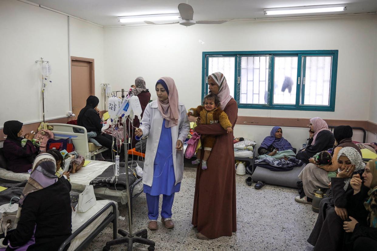 Palestinian women and infants displaced from northern Gaza receive medical care at a clinic in Rafah, in the southern Gaza Strip, on Feb. 29, 2024.