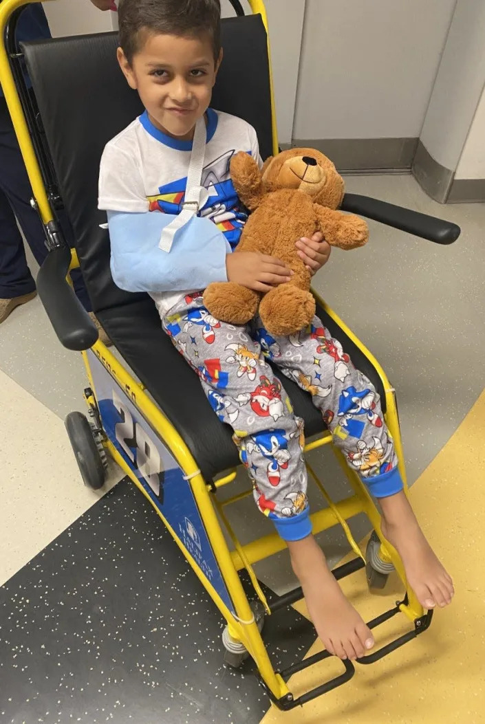 David Alamos, 5, of Nashville, Tennessee, smiles as he leaves Halifax Health Medical Center in Daytona Beach on Monday afternoon. David was injured by a car that crashed on the beach and struck him in the ocean. The boy suffered open cuts to his chest and arm.