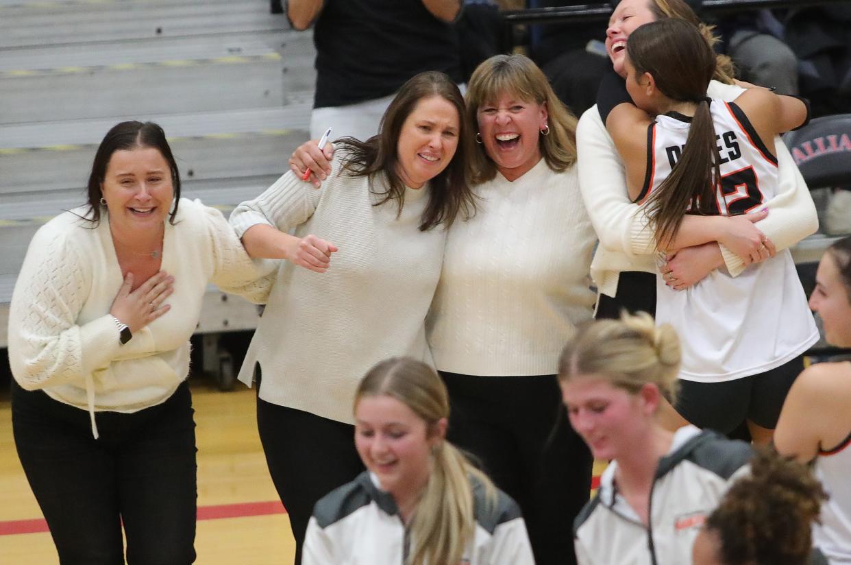 The Marlington volleyball coaches, including head coach Stephanie Tortola, second from left, celebrates after a five-set win over Kenston in a Division II regional semifinal, Thursday, Nov. 2, 2023, at Alliance High School.