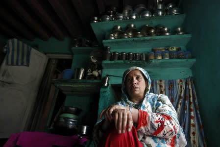 Haseena Malik, mother of Uzair Maqbool Malik, sits inside her kitchen in south Kashmir's Shopian