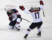 Meghan Duggan of the United States (10) reacts to her goal against Canada as Jocelyne Lamoureux of the United States (17) skates in to congratulate her during the second period of the women's gold medal ice hockey game at the 2014 Winter Olympics, Thursday, Feb. 20, 2014, in Sochi, Russia. (AP Photo/Julio Cortez)