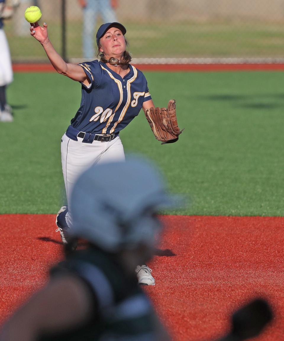 Talmadge's Ashlyn Severns throws to first base to get the Greenville player at out first during the Div. II state semifinal softball at Firestone Stadium in Akron.