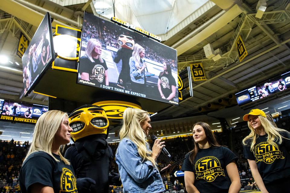 Laura VandeBerg interviews Felicity Taylor, left, and Nanea Estrella during a NCAA wrestling dual between Iowa and California Baptist, Sunday, Nov. 13, 2022, at Carver-Hawkeye Arena in Iowa City, Iowa. 