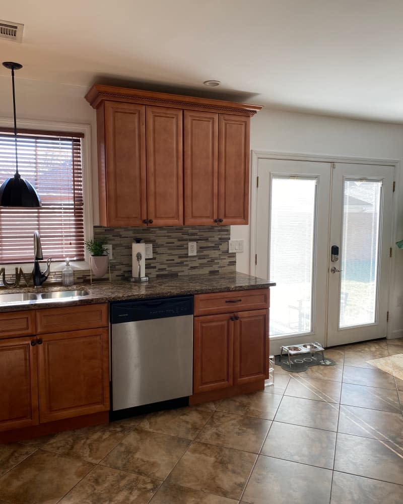 Brown backsplash and countertops in kitchen before renovation.