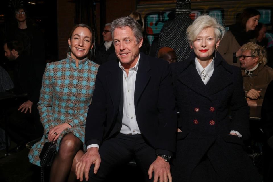 Anna Elisabet Eberstein, from left, Hugh Grant and Tilda Swinton attend the Chanel Metiers d’Art show in Manchester Thursday (Vianney Le Caer/Invision/AP/PA) (AP)