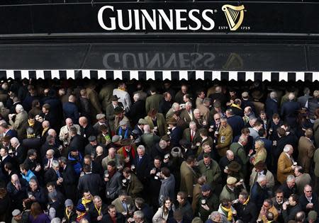 Racegoers gather at the Guinness Village during the Cheltenham Festival horse racing meet in Gloucestershire, western England March 11, 2014. REUTERS/Eddie Keogh