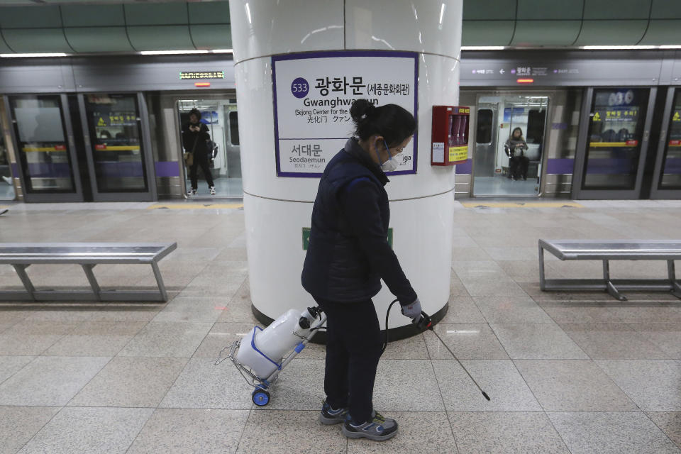 An employee disinfects the platform in hopes to prevent transmission of the coronavirus at a subway station in Seoul, South Korea, Tuesday, Jan. 28, 2020. Deaths from a new viral disease that is causing mounting global concern rose by 25 to at least 106 in China on Tuesday as the United States and other governments prepared to fly their citizens out of the locked-down city at center of the outbreak.(AP Photo/Ahn Young-joon)