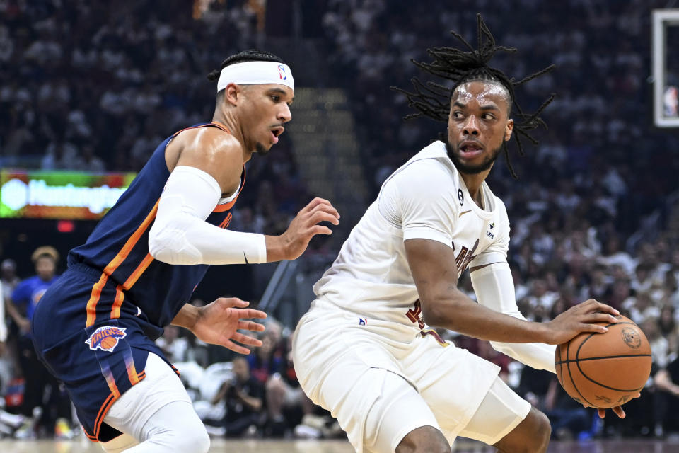 Cleveland Cavaliers' Darius Garland is defended by New York Knicks' Josh Hart during the first half of Game 1 in a first-round NBA basketball playoffs series Saturday, April 15, 2023, in Cleveland. (AP Photo/Nick Cammett)