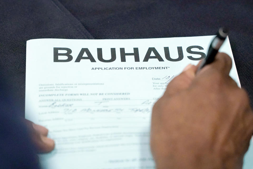 An applicant fills out a job employment form during the Lee County Area Job Fair in Tupelo, Miss., Tuesday, Oct. 12, 2021. Employers representing a variety of manufacturing, production, service industry, medical and clerical companies attended the day long affair with an eye towards recruitment, hiring, training and retention. (AP Photo/Rogelio V. Solis)