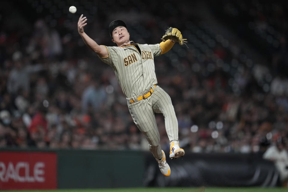 San Diego Padres third baseman Ha-Seong Kim tries to field an infield single hit by San Francisco Giants' Austin Slater during the seventh inning of a baseball game in San Francisco, Monday, Sept. 25, 2023. (AP Photo/Jeff Chiu)