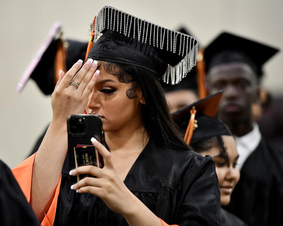 WORCESTER - Nya Sanchez checks herself with her phone as North High School graduates line up for procession for commencement at the DCU Center Wednesday, June 8, 2022.