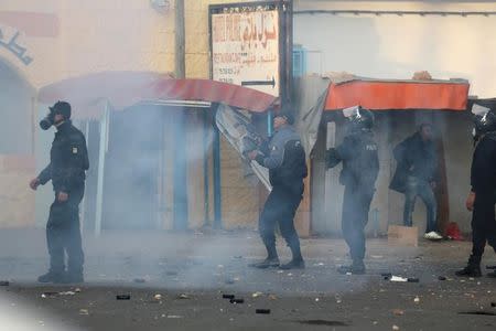 Riot police officers clash with protesters during a demonstration over jobs in Ben Guerdane, Tunisia January 14, 2017. REUTERS/Stringer